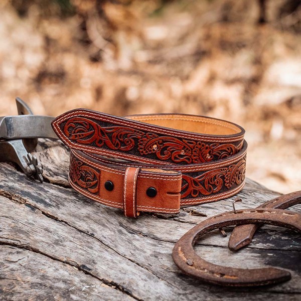 A brown full grain leather belt for men  featuring tooled vines 